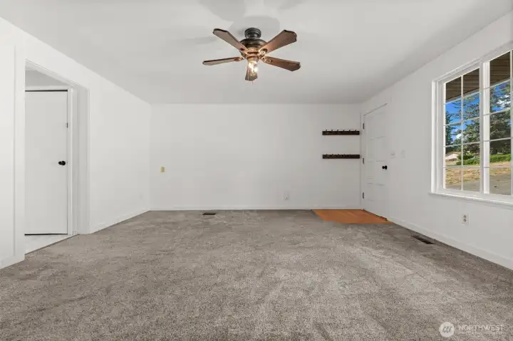 Enjoy a large, open living room that flows effortlessly into the kitchen, highlighted by windows that frame views of the street and driveway.