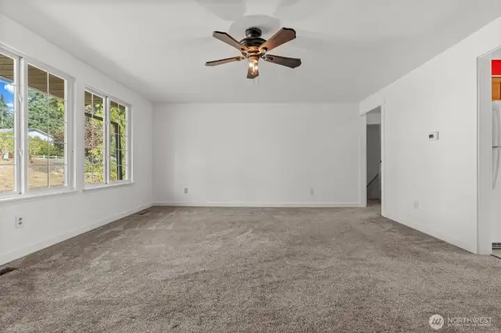 Enjoy a large, open living room that flows effortlessly into the kitchen, highlighted by windows that frame views of the street and driveway.