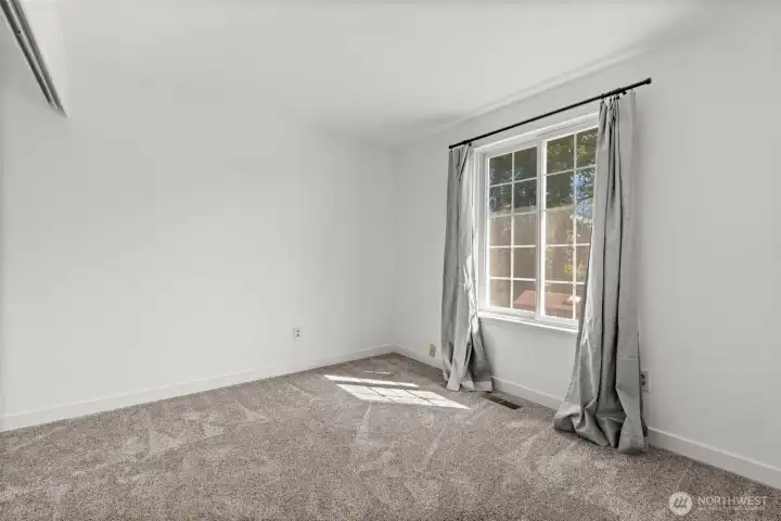 A second bedroom on the main floor offers easy access to the main-floor bathroom and enjoys views of the backyard.