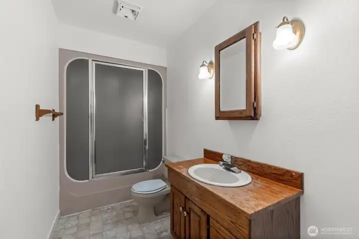 Downstairs living is complete with a full bathroom, perfectly positioned for the third bedroom, additional room, and spacious bonus area.