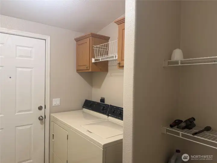 Laundry room with storage and side door