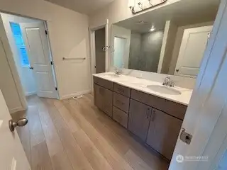 uniform cabinetry and quartz countertops throughout including master bath with standup shower