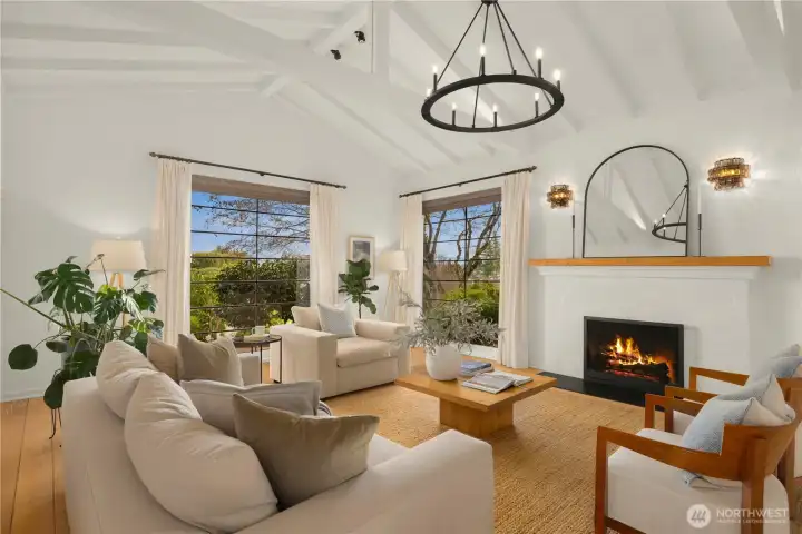 Stepping into the living room, you immediately appreciate the soaring ceilings with wood beams, floor to ceiling windows capturing the veiws, beautiful inlaid white oak floors, and new gas fireplace.