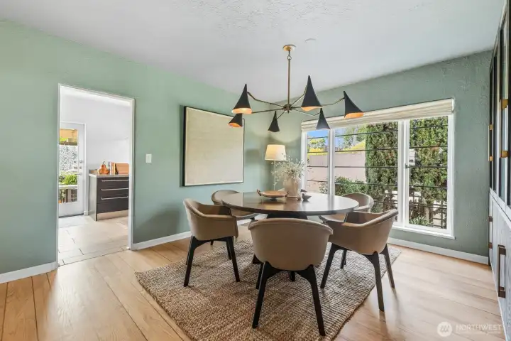 Spacious dining room with a large window and custom shades.