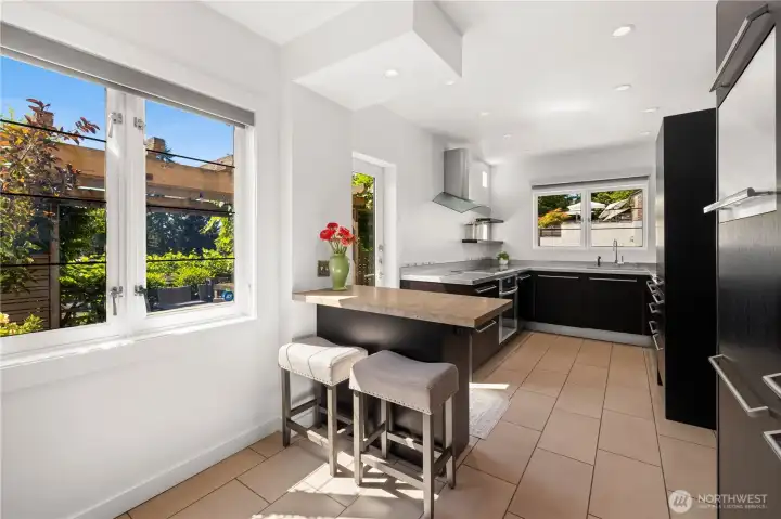 Utilitarian kitchen with so much light and functionality. An all German design features Miele appliances and a Sub-Zero refrigerator.