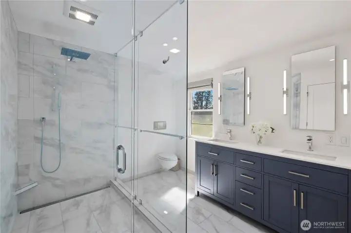 En suite bathroom with heated floors (even in the shower!) There is a walk-in closet just to the right of photo.