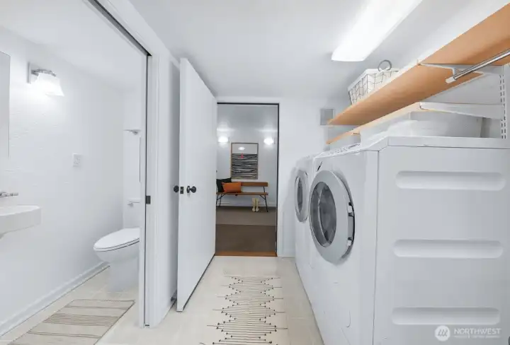 Laundry room with Miele washer and dryer. To the left is the 3/4 bathroom for guests. Straight-away is another bonus room perfect for storage or a Peleton!