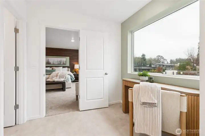 Large windows for light in the primary bath with a nook for makeup vanity or linen storage cabinet.  Actual home is under construction and finishes, colors, and materials may vary. See site agent for details.