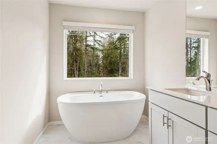 Spa-inspired primary bathroom showcasing a freestanding soaking tub. Photos are representative only and may display different color package and/or upgrades.