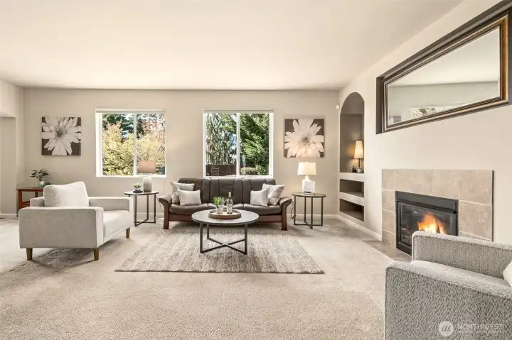 The tiled gas fireplace is flanked by arched, recessed built-in shelving, with plug-ins for specialty lighting.