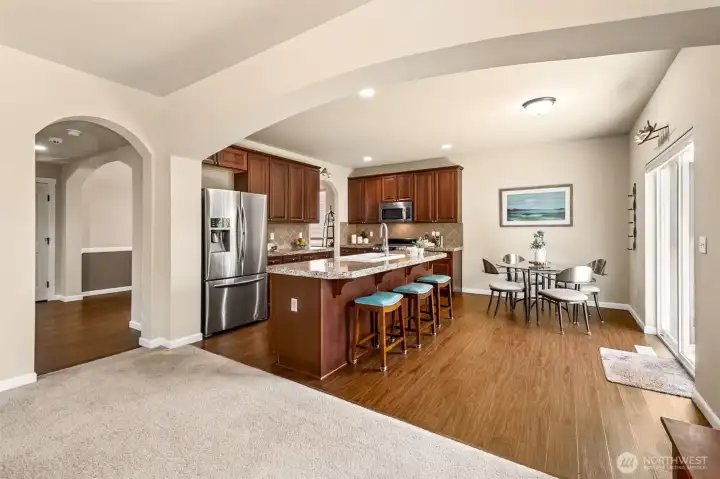 Plenty of rich wood cabinets, with tiled backsplash