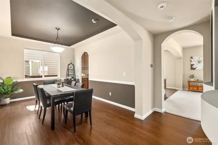 Light-filled dining room with coffered ceiling, classic chair rail detailing, and an open, welcoming feel—perfect for gatherings.