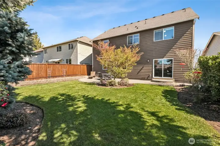 Nicely arranged plantings and the perfect level lawn for play!