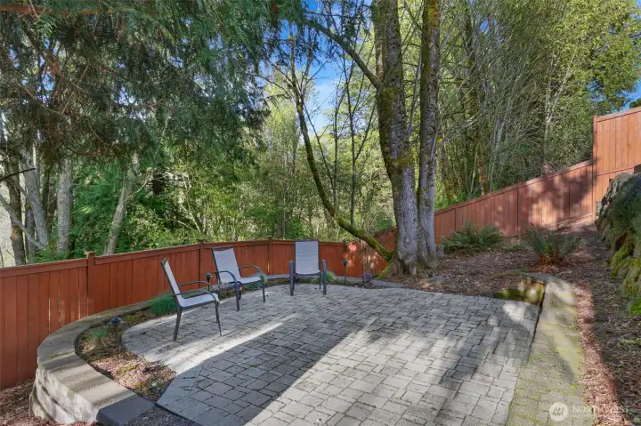 Lower patio next to wooded area
