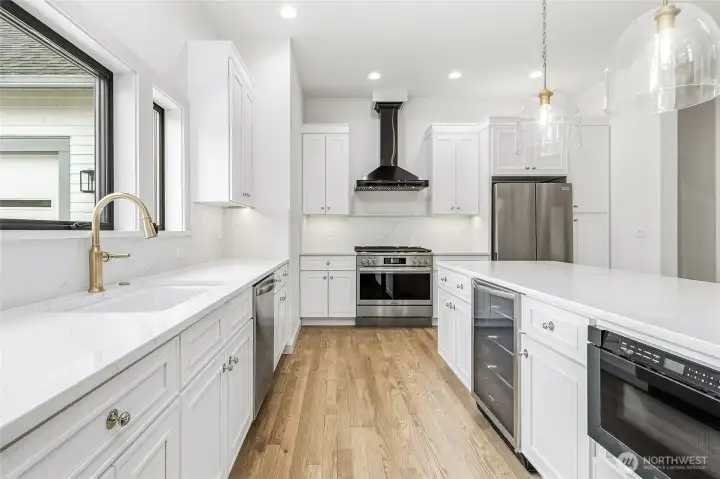 Wine fridge and microwave drawer tucked neatly in center island. Wine fridge and microwave drawer tucked neatly in center island.