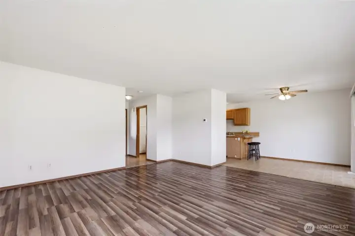 Living room looking toward kitchen, half bath, and entry