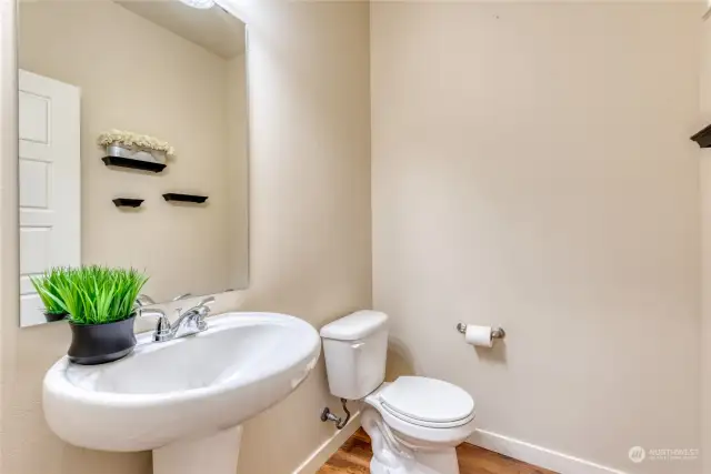 Nicely tucked around the corner from the kitchen is the main floor powder room.