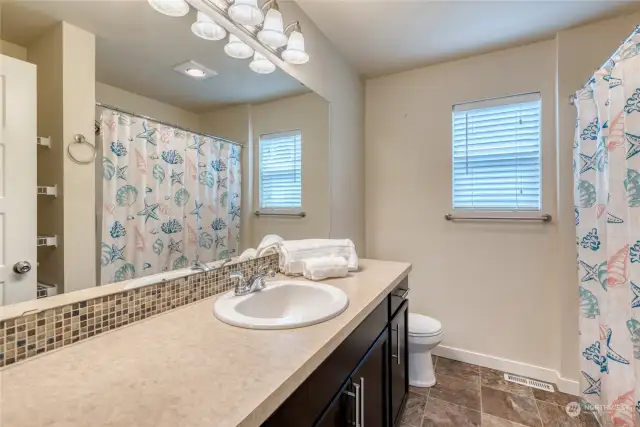 Conveniently central to all the bedrooms is the full guest bathroom with extended vanity counter space.
