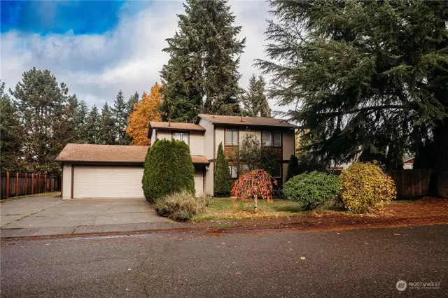 Mature landscaping surrounds home