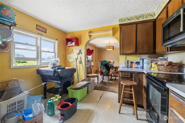 From utility room, looking through kitchen into dining room