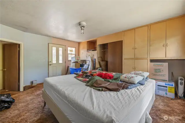 Primary bedroom with door onto back deck