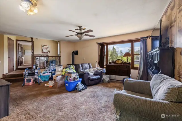 Living area with entry and kitchen in the distance