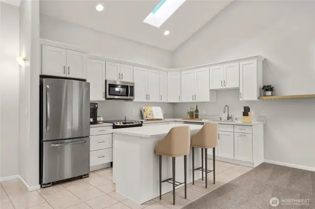 Light filled, recently updated kitchen complete with skylights, island and eating space.