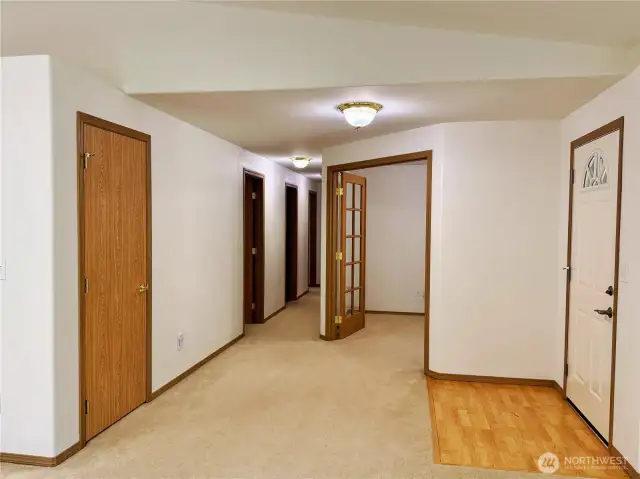 French doors into office, hall leads to 3 bedrooms