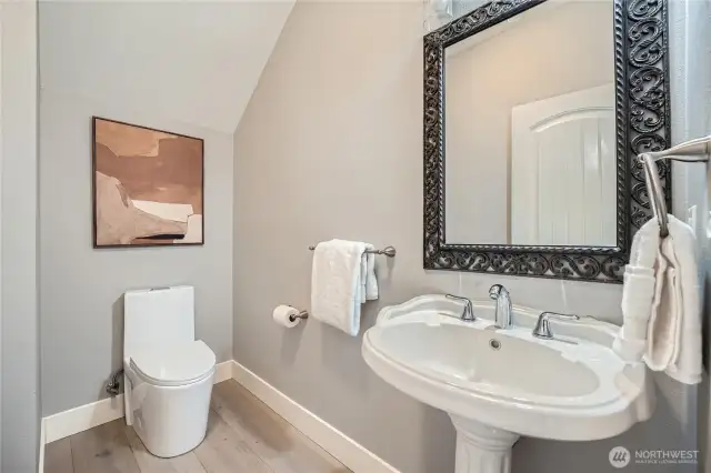 Updated main level 1/2 bath with modern fixtures and stylish finishes, offering convenience and contemporary appeal.