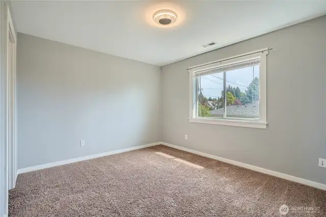 Spacious bedroom number 4 on upper level featuring fresh paint, creating a clean and inviting atmosphere perfect for relaxation and personalization.