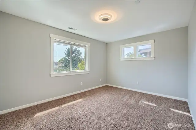 Spacious bedroom number 3 on upper level featuring fresh paint, creating a clean and inviting atmosphere perfect for relaxation and personalization.