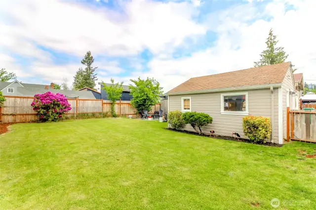 Fully fenced backyard with detached garage providing privacy and plenty of storage.