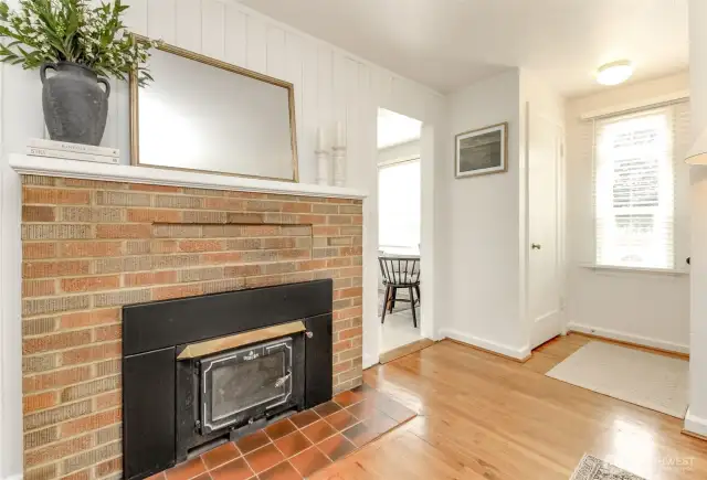 Cozy brick fireplace featuring wood burning insert