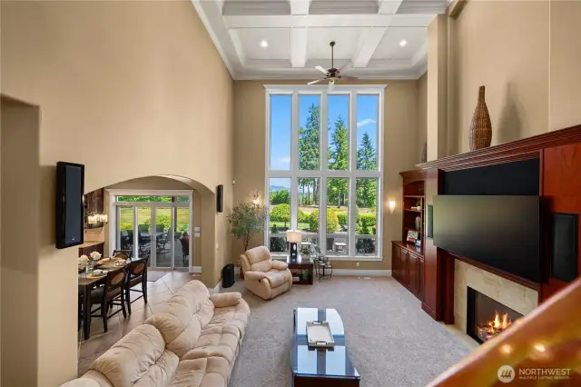 Family room w/territorial views, eating area to the left & covered deck & back yard in background.