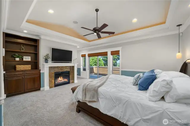 Primary ensuite w/vaulted ceiling, accent lighting, crown, chair rail, gas fireplace w/mantle, built ins.
