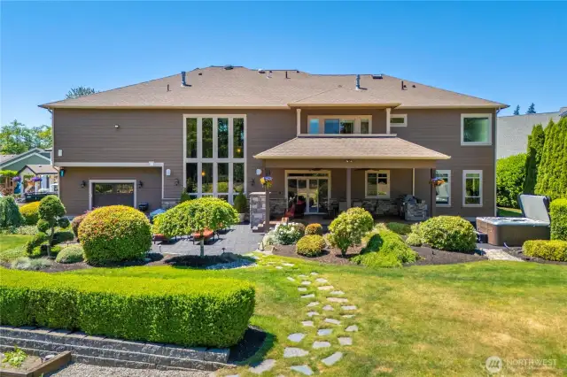 Back of home is great for entertaining. Shop area w/back garage door to the left.