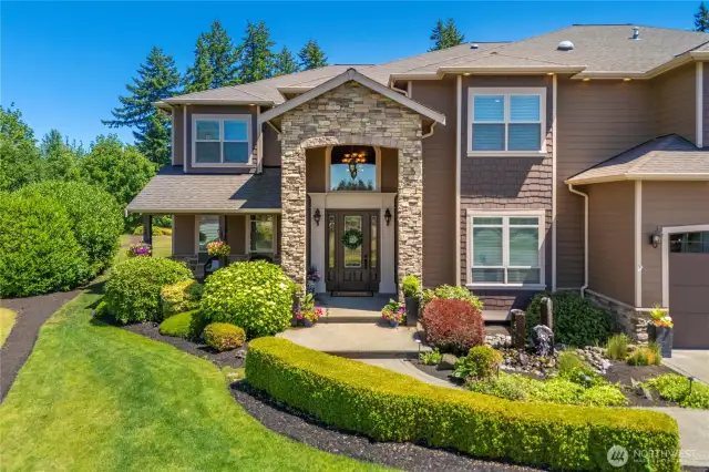 Beautiful covered entry w/stone, water feature & ample exterior lighting.  Hardi plank siding on all sides.