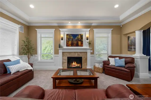 Formal living, coffered ceiling w/double crown molding, gas fireplace w/mantle, wrapped windows & newer carpet.