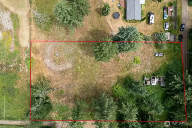 1.26 Acres — Ample space for a custom home, shop, garden, and outdoor living areas. Level main building area with a gentle slope to the North where it levels out again. Water and electricity in the street(pole in front). Previous perk test passed easily.