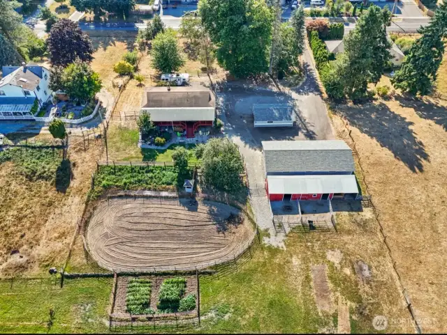 aerial view of arena, house, barn, garden and shops