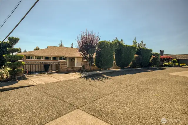 Left front side with gate and driveway on side