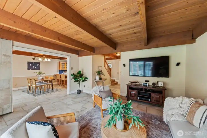 Living room with a generous opening leading into the dining area and kitchen, creating a connected yet defined layout.