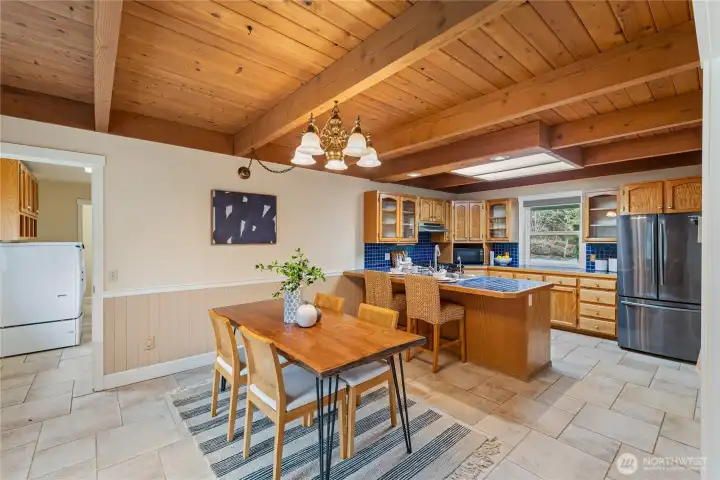 Dining area with gorgeous wood ceilings and plenty of space for gathering, plus an eat-in area in the kitchen for quick breakfasts and casual meals.