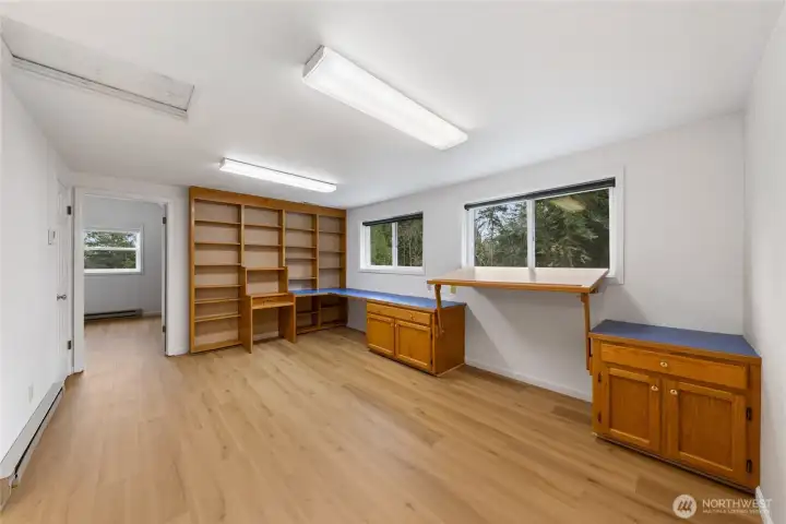 Versatile upper-level bonus room featuring built-in shelving and workspace, perfect for studying, working from home, or hobbies.
