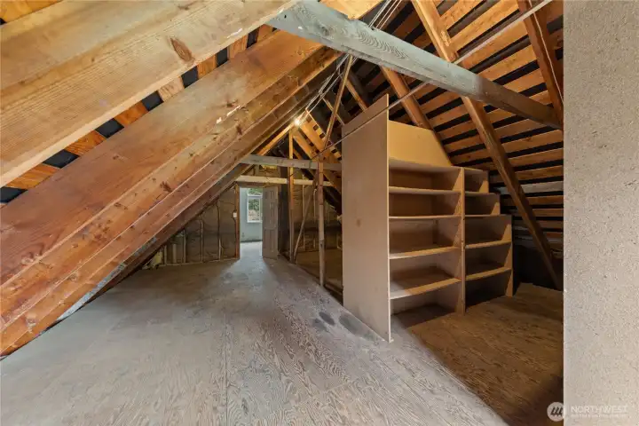 Above the garage is a large unfinished space already equipped with electricity, offering excellent storage now and exciting potential to create future living space such as a studio, gym, or additional room tailored to your needs.