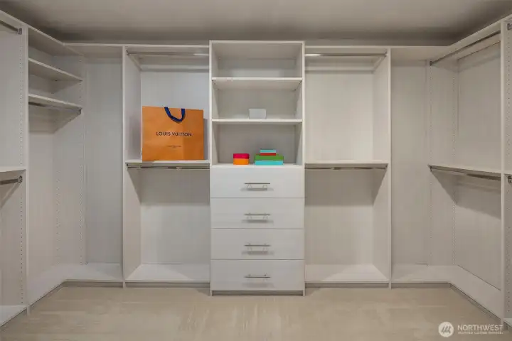 Primary suite features custom closets designed to maxize organization and storage.