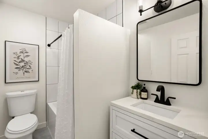 The main floor bath was just remodeled with new tile in the shower, a new tub, a new vanity and mirror with storage.