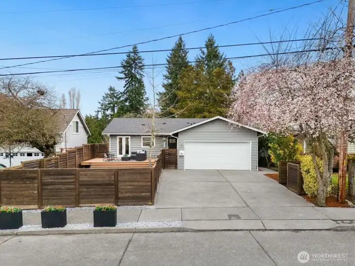 There's a 2-car attached garage and more parking in the driveway and a fenced in area on the right for your garbage, recycling and yard waste bins.