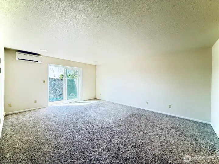 Primary bedroom with access to the enclosed patio and ensuite