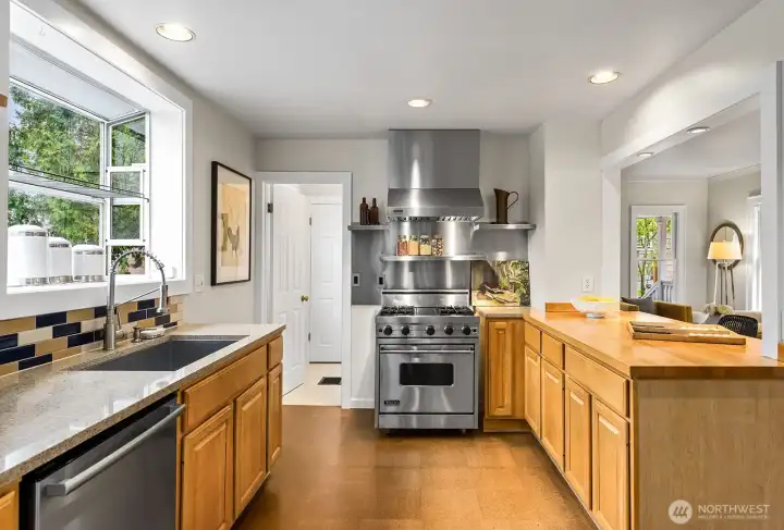 Kitchen with a commercial style Viking stove/oven, hardwood counter, and cork floors.